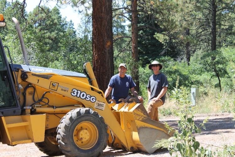 Mike and Mark work the backhoe in Durango
